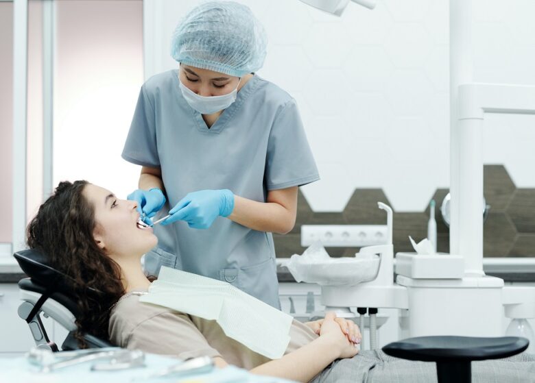 https://www.pexels.com/photo/woman-in-blue-scrub-suit-standing-beside-woman-in-brown-shirt-lying-on-dental-chair-4269693/